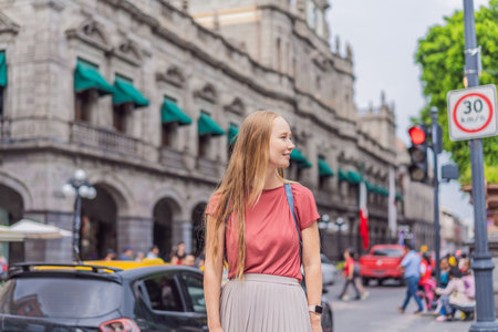 Female tourist walking through the colorful colonial streets of Puebla, Mexico. Travel, cultural exploration, and vibrant architecture conceptの写真素材