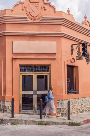 Female tourist walks through the colonial streets San Cristobal de las Casas, Mexico. Cultural...