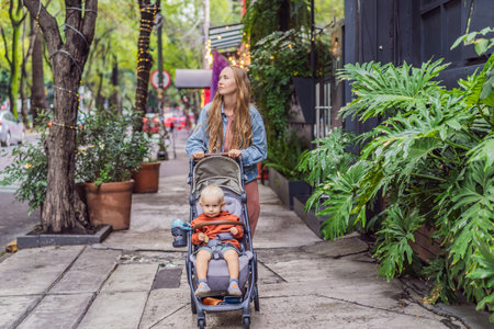Mother with her son exploring lush streets of Condesa, Mexico City. Family adventure in a vibrant...