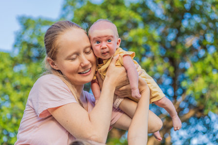 Young mother, teenage son, and one-month-old baby enjoying quality family time in the park. Multigenerational bonding and outdoor family love conceptの写真素材