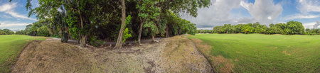 Scenic panorama of a tropical golf course surrounded by lush jungle. Serene landscape ideal for...