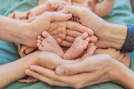 Newborn tiny feet surrounded by family. Symbol of love, protection, and strong family bonds....