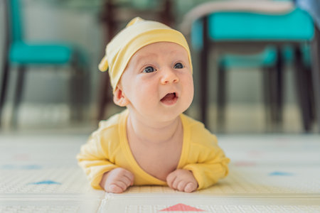 One-month-old baby lying on tummy and curiously observing surroundings. Infant tummy time for neck...