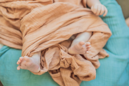 Newborn baby comfortably resting in a cozy baby nest. Safe and peaceful sleep concept for infants
