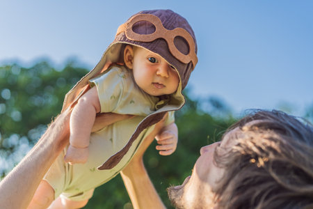 Father lifting baby in a pilot hat. Future pilot dream, aviation inspiration, and joyful family...