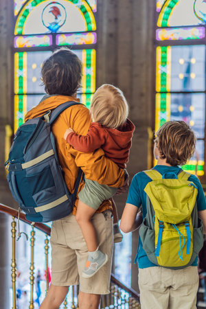 Father with his two sons visiting Chapultepec Castle in Mexico City, enjoying a cultural family trip together. Tourism, heritage exploration, and family bonding vacation conceptの写真素材