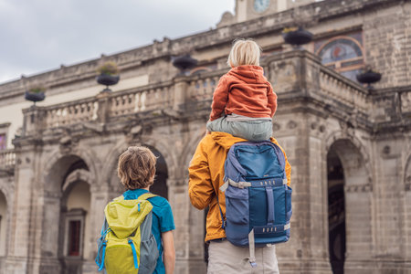 Father with his two sons visiting Chapultepec Castle in Mexico City, enjoying a cultural family trip together. Tourism, heritage exploration, and family bonding vacation conceptの写真素材