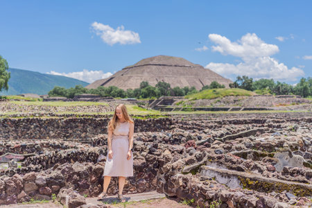 Female tourist standing in front of Teotihuacan pyramids in Mexico, enjoying sightseeing, adventure, and cultural heritage. Travel, tourism, and exploration conceptの写真素材