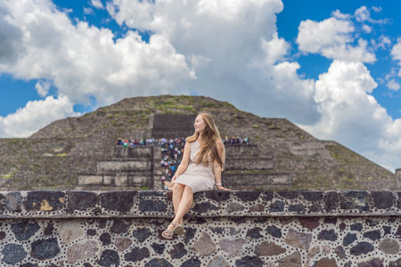 Female tourist standing in front of Teotihuacan pyramids in Mexico, enjoying sightseeing, adventure,...