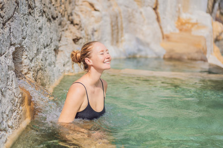 Female tourist exploring Grutas Tolantongo in Mexico, enjoying natural hot springs, scenic caves, and outdoor adventure. Travel, wellness, and sightseeing conceptの写真素材