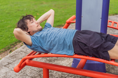 Man exercising in an urban park, stretching and training outdoors on a sunny day, concept of active...