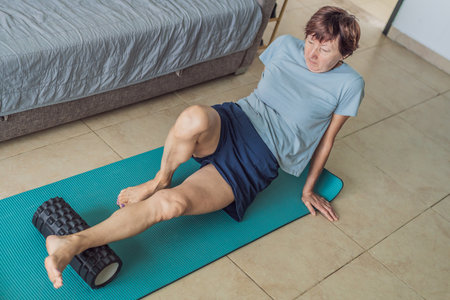 Elderly woman practicing yoga in her cozy living room, stretching on a mat and maintaining balance....