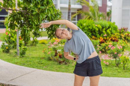 Unaltered woman exercising in a park, enjoying movement, fresh air and a healthy outdoor routine....