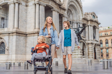 Mother tourist with her two sons in front of Palacio de Bellas Artes in Mexico City, enjoying family travel, architecture, and cultural heritage. Family travel and bonding conceptの写真素材