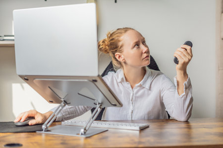 Woman working in her home office, focused on her laptop and daily tasks, creating a calm and productive workspace. Remote work, professional lifestyle and modern productivity concept representing balance, comfort and efficiency at homeの写真素材