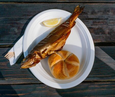 Smoked trout whole with horseradish and garnish. Gourmet grilled salmon fish on a plate. Delicious...