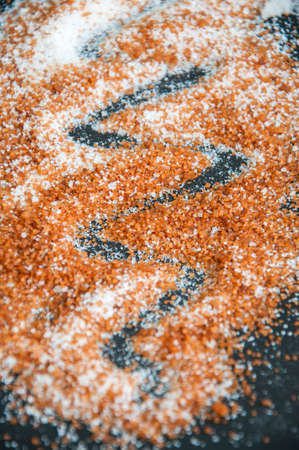 Sifting brown and white sugar on a black backgroundの写真素材