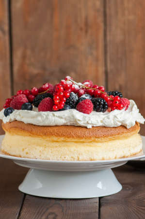 Close up of fluffy Japanese cotton cheesecake with wipped cream cheese frosting and garnished with...