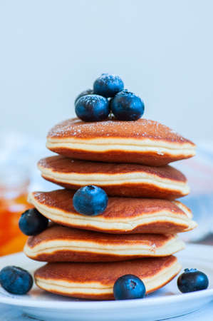 Close up of stack of homemade pancakes with bluberries in a white plate. Healthy breakfast concept. の写真素材
