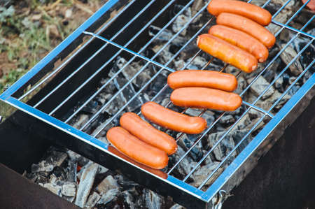 Barbecue grill with sausages, close-up. Party on picnic.の写真素材