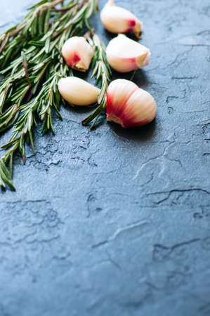 Garlic cloves and rozmary on a black backgroundの写真素材
