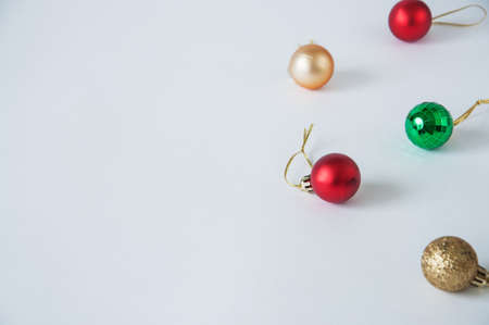 Red Gold Green Christmas Balls on White Background. Selective Focus. Copy Space. Close Up.