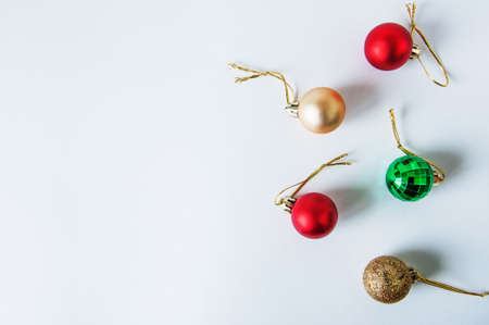Red Gold Green Christmas Balls on White Background. Selective Focus. Copy Space. Top View.の写真素材