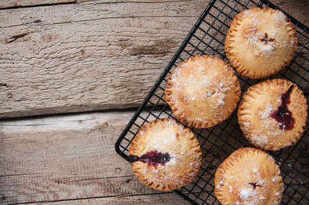 Blueberry hand pies sprinkled with sugar on wooden table. Top view.の写真素材