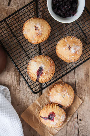 Blueberry hand pies sprinkled with sugar on wooden table. Top view.の写真素材