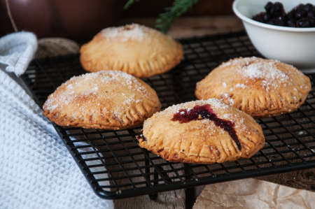 Blueberry hand pies sprinkled with sugar on wooden table.の写真素材