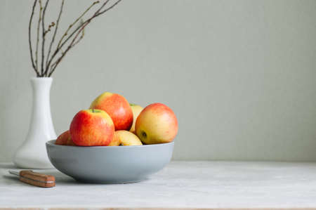Ripe apples in a bowl on a white background. Autumn mood concept.の写真素材