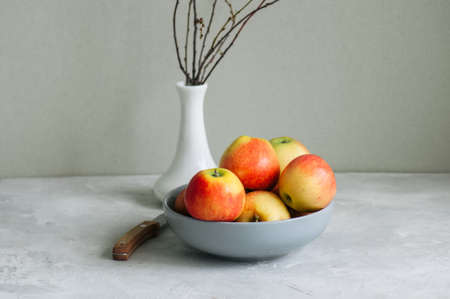 Ripe apples in a bowl on a white background. Autumn mood concept.の写真素材