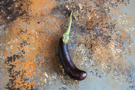 One eggplant on a rusty background. Top view and copy space.の写真素材