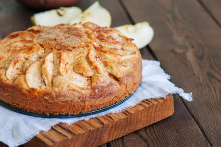 Easy apple tea cake on a wooden background. Homemade baking.の写真素材