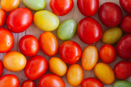 Background of bright colorful tomatoes cherry. Top view.の写真素材