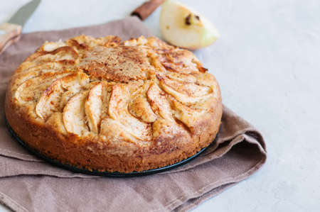 Easy apple tea cake on a linen napkin. White background and close up.の写真素材
