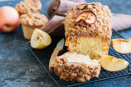 Apple cinnamon streusel cake on a wire rack on a blue stone background. View from above.の写真素材