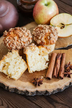 Apple cinnamon streusel muffins on a wooden board. Wooden background.の写真素材