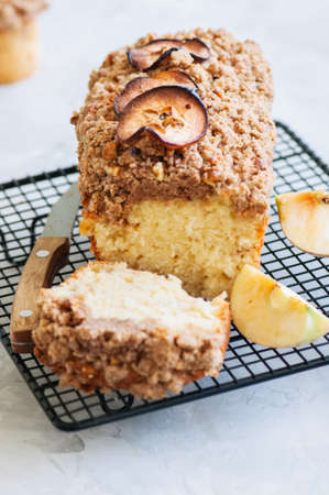 Apple cinnamon streusel cake on a wire rack on a white stone background. View from above.の写真素材