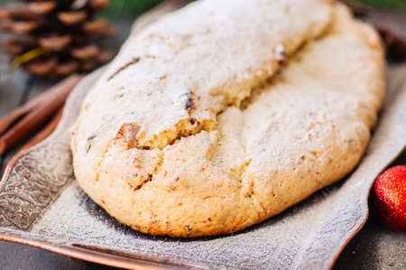 Christmas Stollen served on vintage tray on a wooden background. Festive european baking.の写真素材