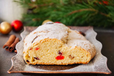 Christmas Stollen served on vintage tray on a wooden background. Festive european baking.の写真素材