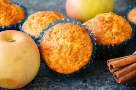 Homemade apple cheese muffins. Blue stone background. Seasonal baking. Close up.の写真素材