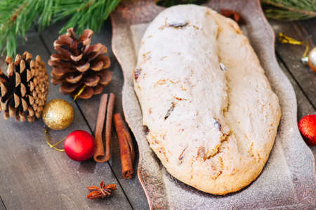 Christmas Stollen served on vintage tray on a wooden background. Festive european baking.の写真素材