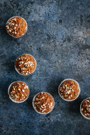 Healthy carrot cake muffins on a blue stone background. Top view.の写真素材