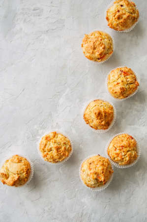 Homemade savory muffins with fish and cheese on a white stone background. Healthy snack or breakfast meal.の写真素材