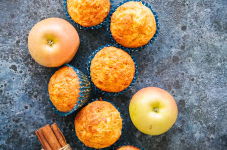Homemade apple cheese muffins on a wire rack. Blue stone background. Seasonal baking.の写真素材