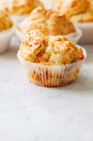 Homemade savory muffins with fish and cheese on a white stone background. Healthy snack or breakfast meal.の写真素材