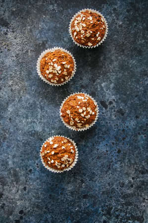 Healthy carrot cake muffins on a blue stone background. Top view.の写真素材