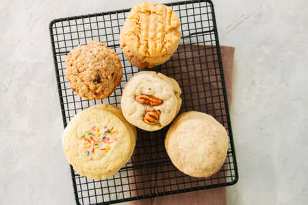 Set of festive cookies on a wire rack. Peanut butter, pecan, oatmeal, shortbread, snickerdoodle...