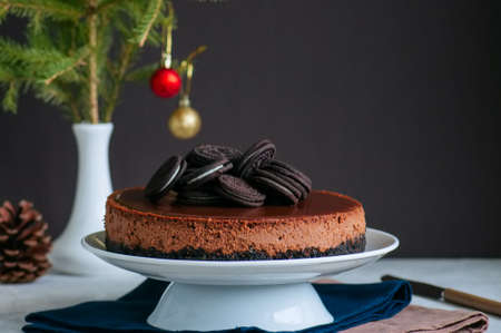 Chocolate cheesecake with cookies on a white plate.の写真素材
